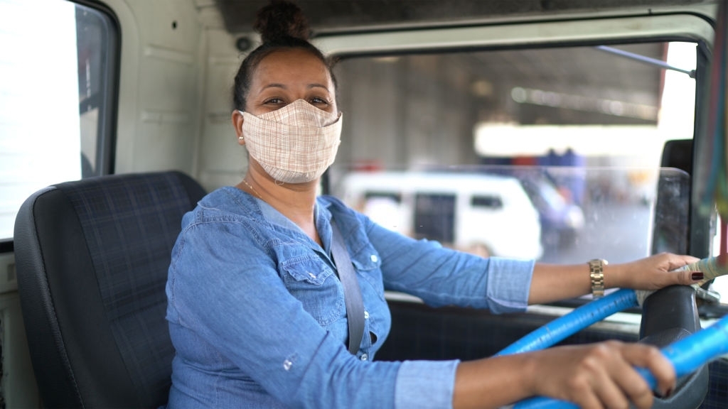 Portrait of a female truck driver using face mask